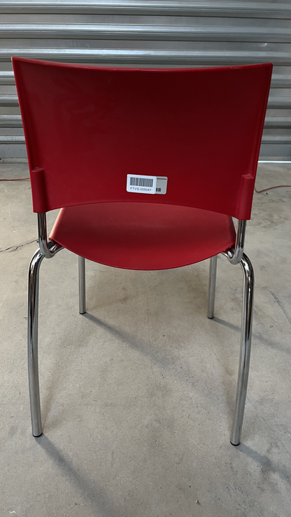 Chaise en plastique rouge sur pieds en métal gris